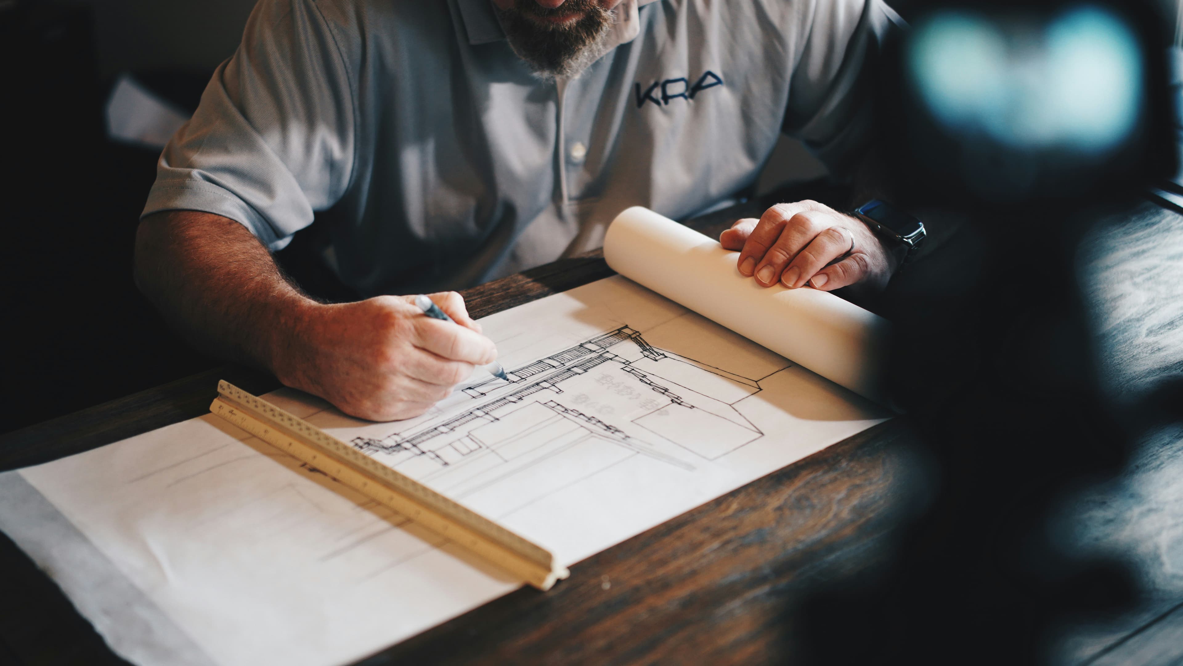 Architect and consultant reviewing property blueprints for due diligence