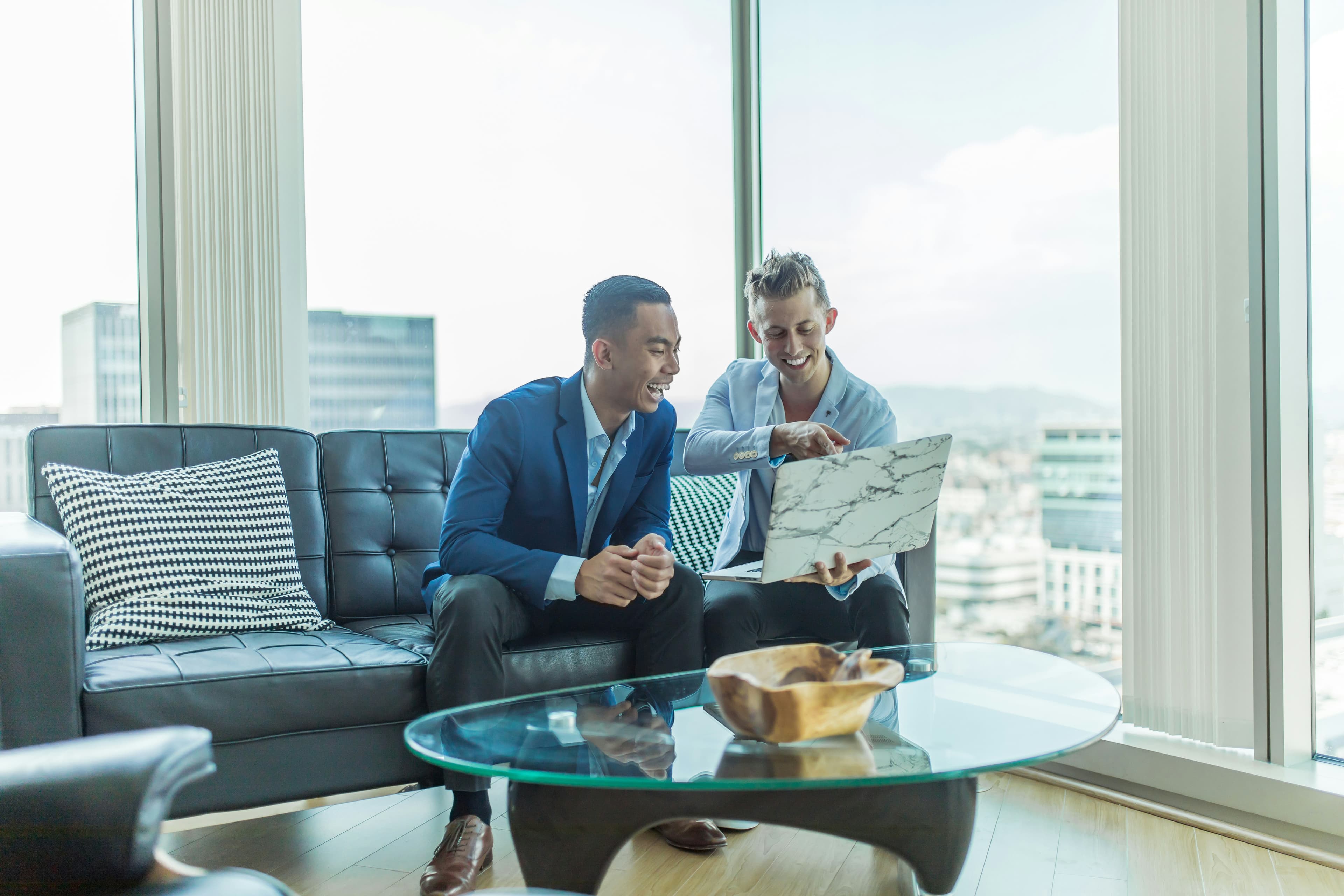Real estate consultant shaking hands with a client after an advisory meeting