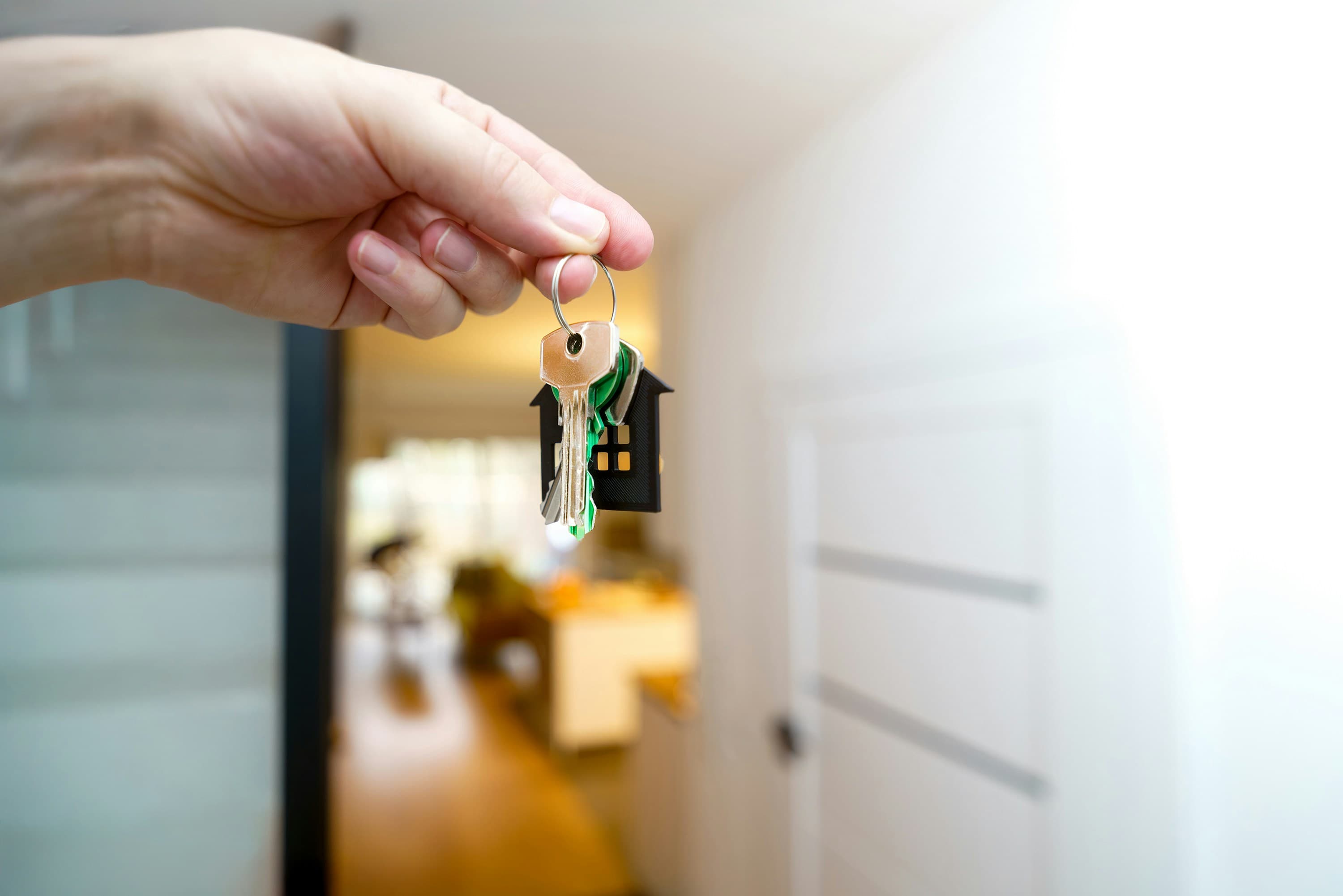 Real estate agent handing over property keys after a sale